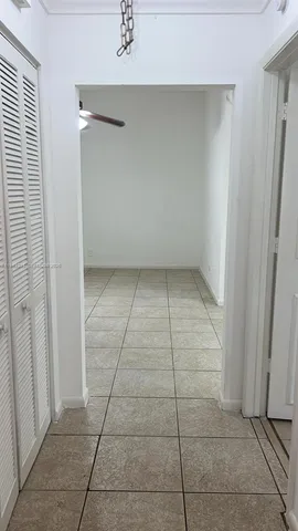 an empty room with closet and a bathroom