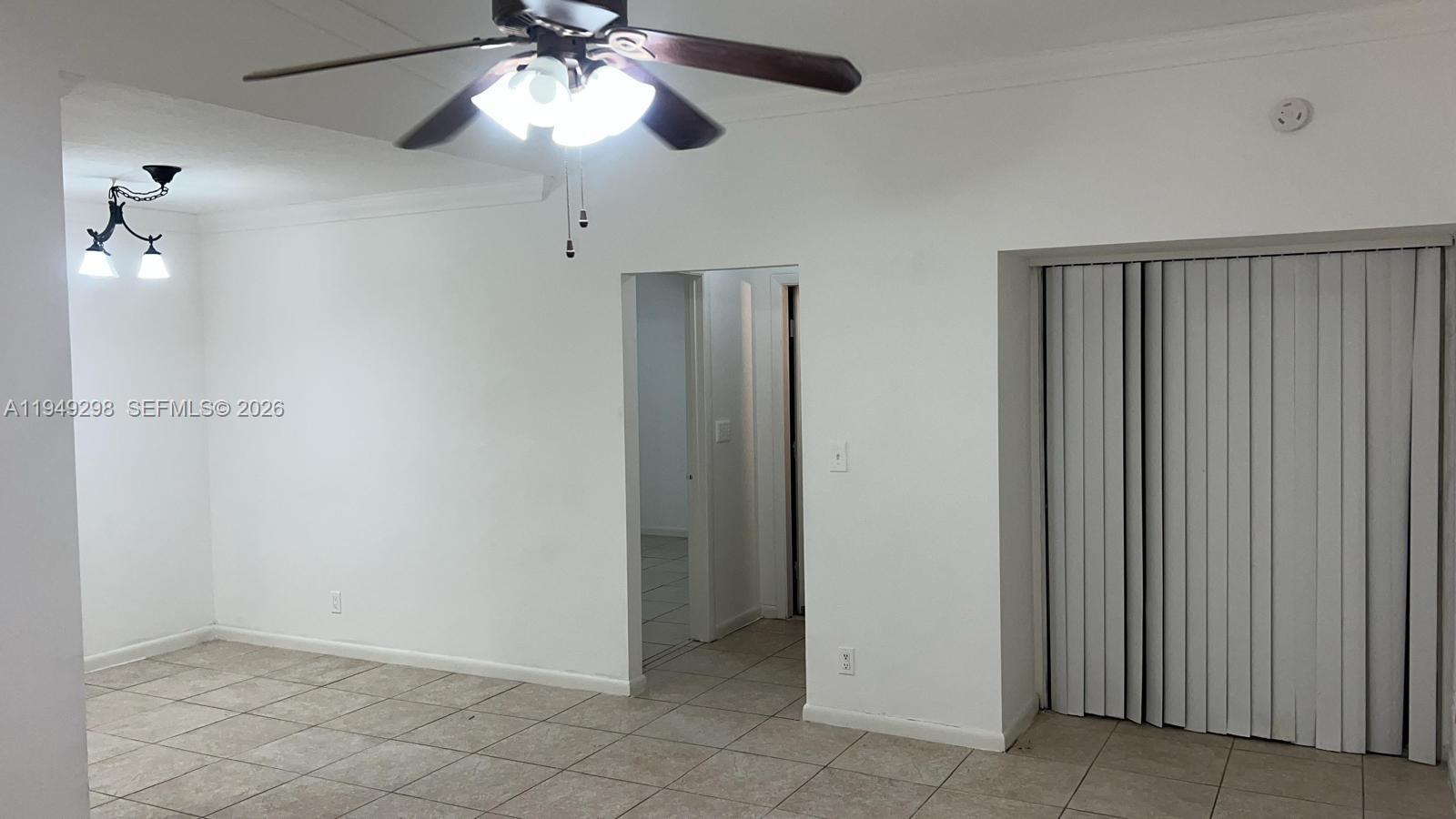 1802 Waterview Circle, Unit 1802 Palm Springs, FL 33461 - Photo 15 of 20 an empty room with closet and a chandelier fan