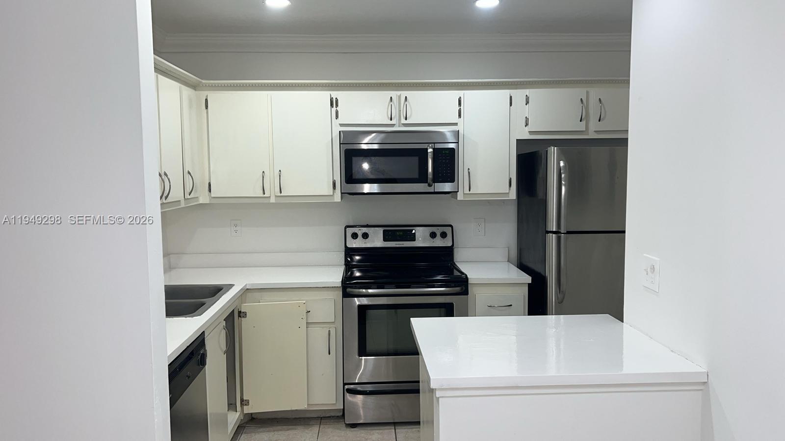 1802 Waterview Circle, Unit 1802 Palm Springs, FL 33461 - Photo 16 of 20 a kitchen with a sink and steel appliances
