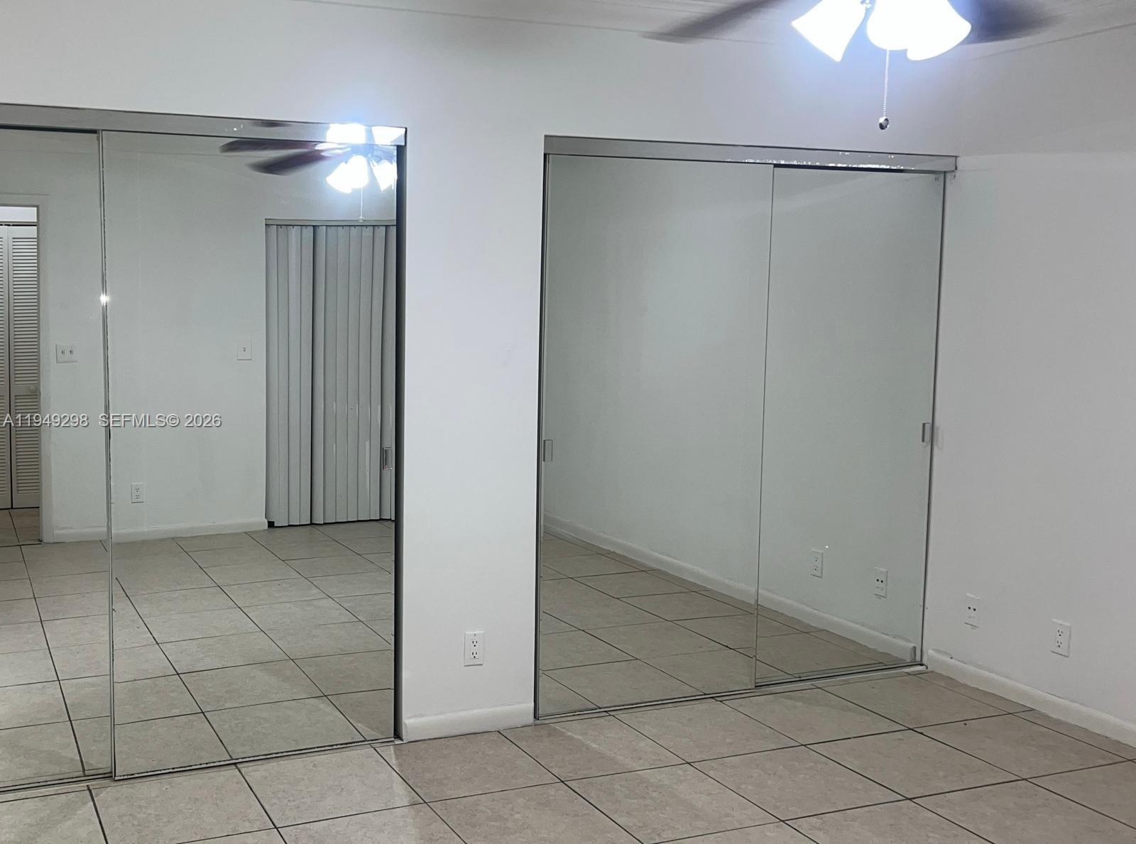 1802 Waterview Circle, Unit 1802 Palm Springs, FL 33461 - Photo 18 of 20 an empty room with closet and a chandelier fan