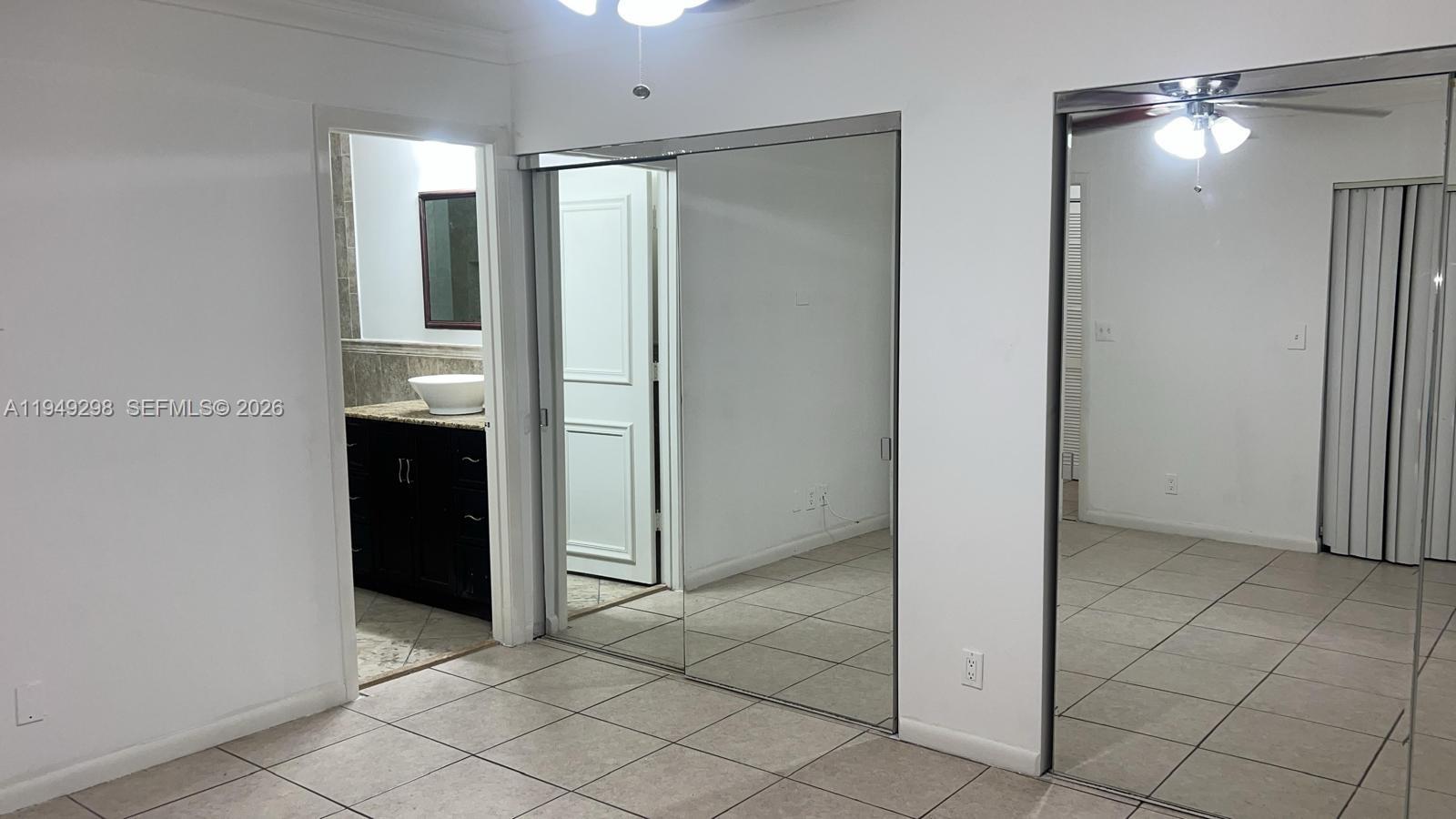 1802 Waterview Circle, Unit 1802 Palm Springs, FL 33461 - Photo 19 of 20 an empty room with closet and a bathroom
