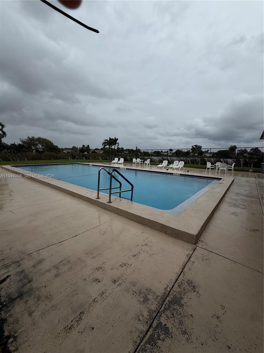 1802 Waterview Circle, Unit 1802 Palm Springs, FL 33461 - Photo 3 of 20 a view of a terrace with lawn chairs and iron fence