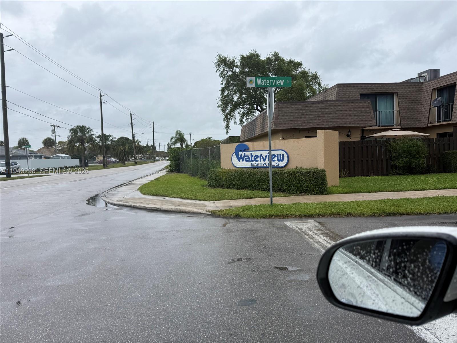 1802 Waterview Circle, Unit 1802 Palm Springs, FL 33461 - Photo 4 of 20 a front view of a house with a yard and garage