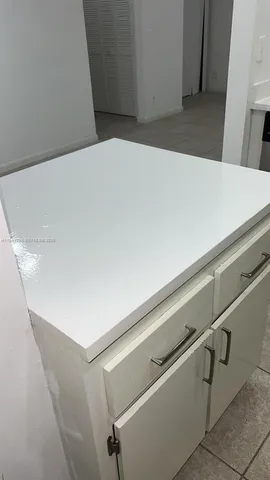 a bathroom with a glass shower door and a sink