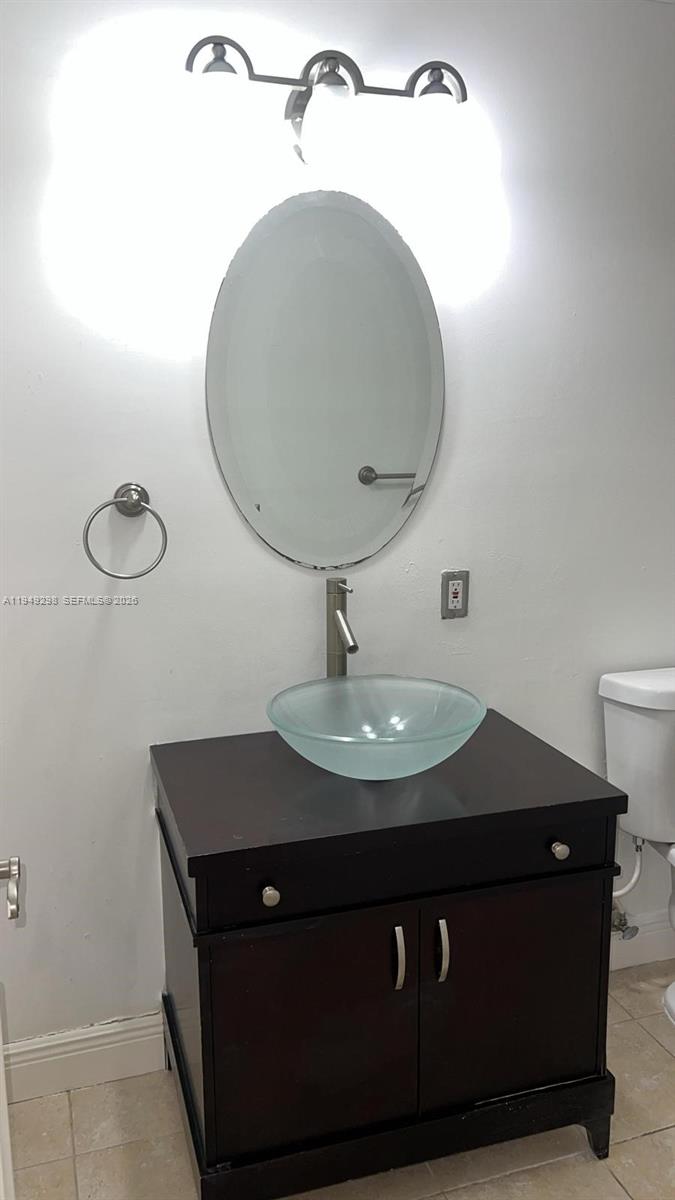 1802 Waterview Circle, Unit 1802 Palm Springs, FL 33461 - Photo 8 of 20 a bathroom with a sink and a mirror