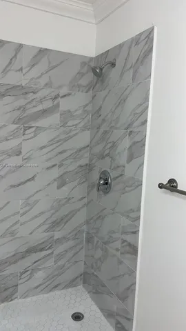 an empty room with a bench and cabinet