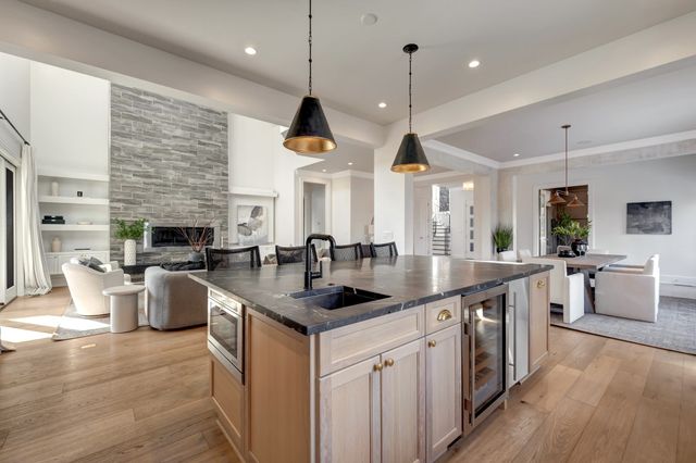 a view of a kitchen with fridge and wooden floor