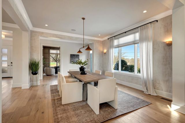 a kitchen with stainless steel appliances granite countertop a lot of counter space and wooden floors