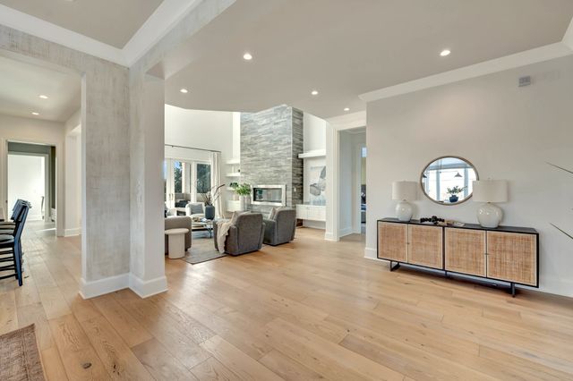 a kitchen with stainless steel appliances granite countertop a stove and a wooden floors