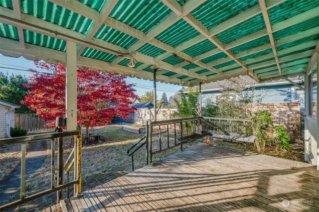 a view of a patio with table and chairs and potted plants