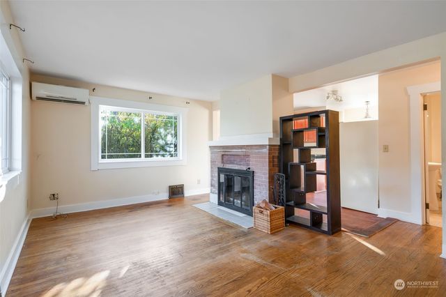 a view of empty room with fireplace and window