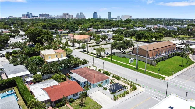 an aerial view of a houses with a city view