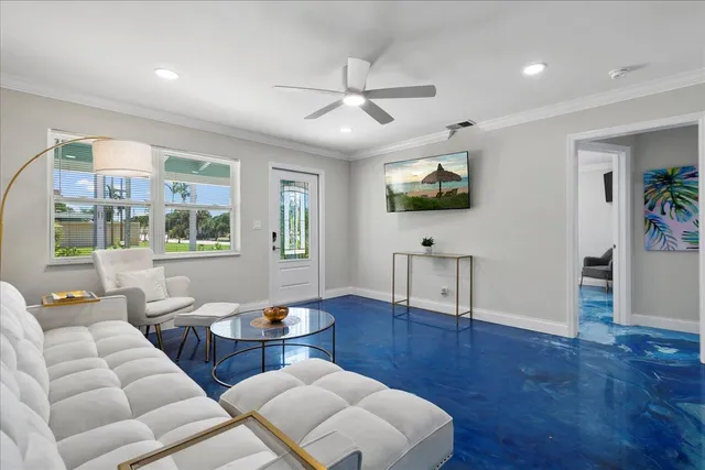 a living room with furniture a wooden floor and a flat screen tv