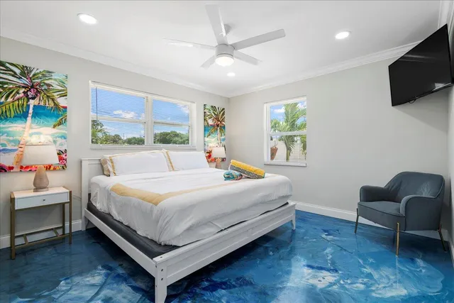 a bedroom with a bed a couch and a flat screen tv