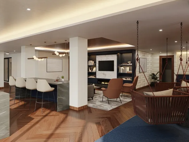 a living room with furniture a rug and kitchen view