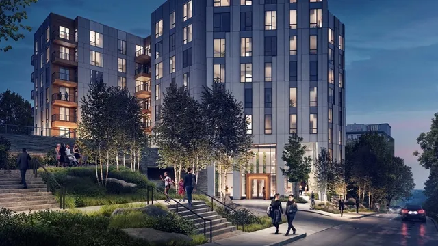 a city street lined with tall buildings and trees