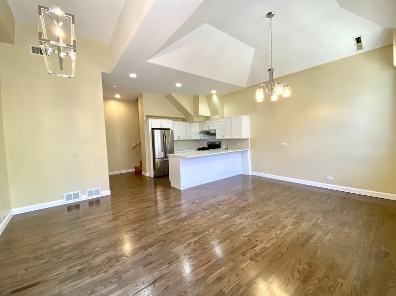 3131 South Benson Street, Unit 10 Chicago, IL 60608 - Photo 3 of 17 a view of a kitchen with a sink and a microwave