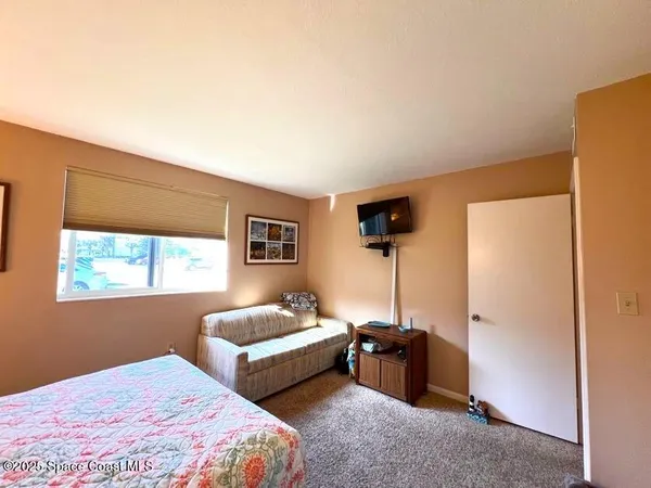 a bedroom with bed and a window