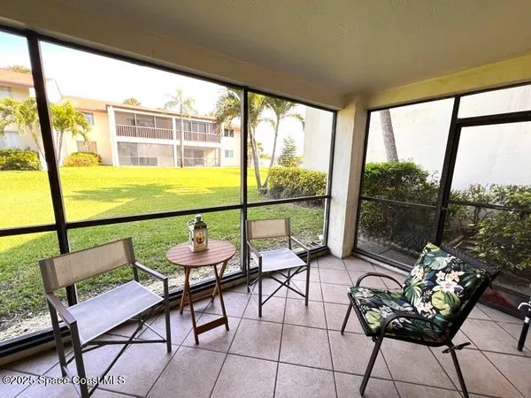 a balcony with furniture and wooden floor