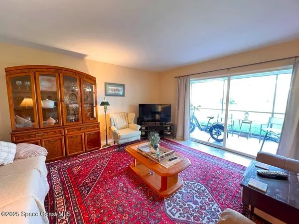 a living room with furniture rug and a table