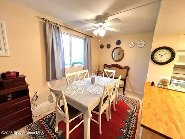 a view of a dining room with furniture and a chandelier