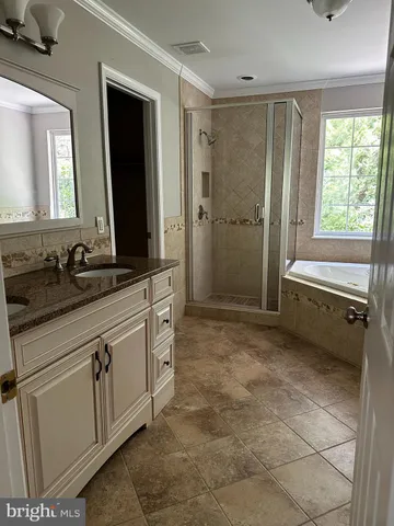 a spacious bathroom with a mirror sink and bathtub