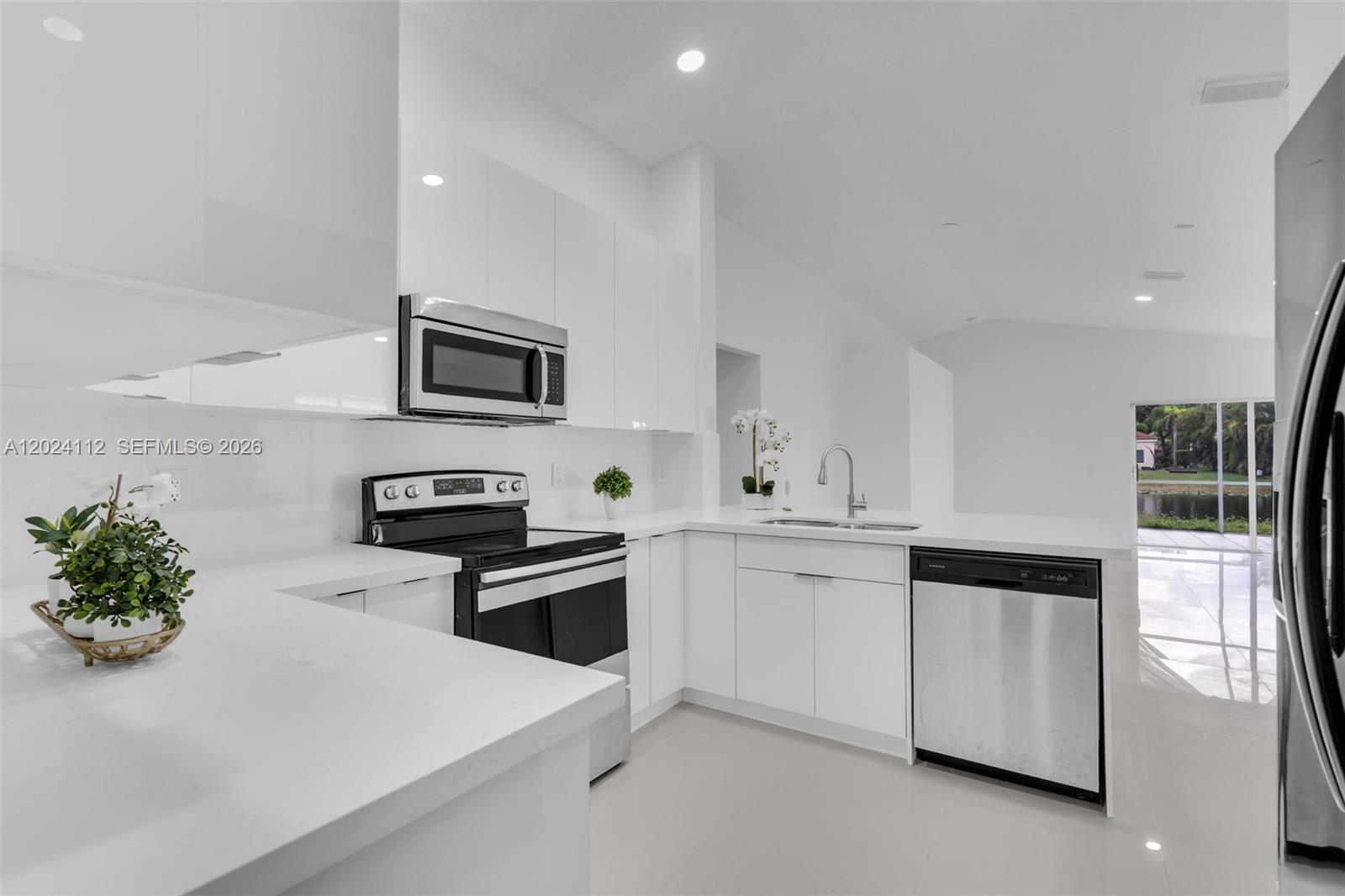 4366 Mahogany Ridge Drive Weston, FL 33331 - Photo 7 of 41 a kitchen with granite countertop white cabinets and stainless steel appliances
