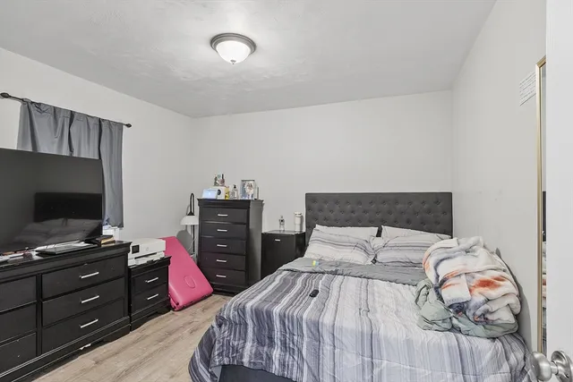 a bedroom with a bed and flat screen tv