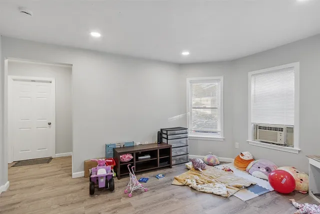 a bedroom with furniture and a wooden floor