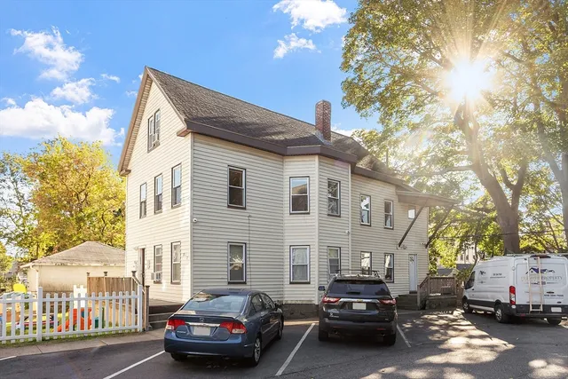 a car parked in front of a white house