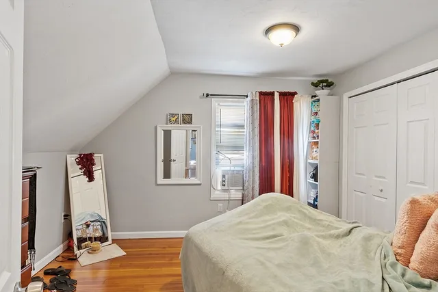 a bed room with a bed and a mirror