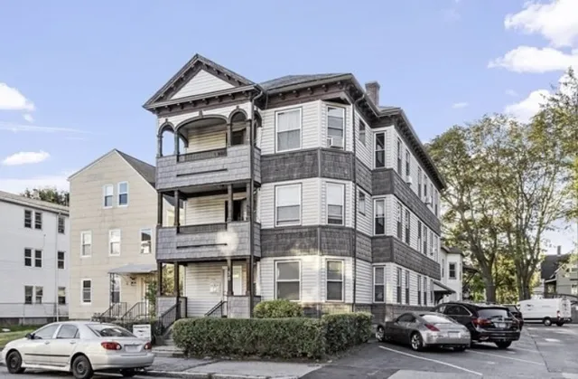 a kitchen with stainless steel appliances granite countertop a table chairs refrigerator and microwave