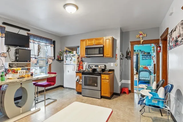 a bedroom with a bed window and mirror