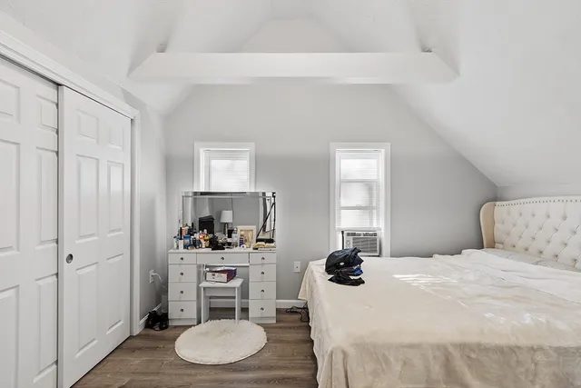 a bedroom with a bed and a chair in it