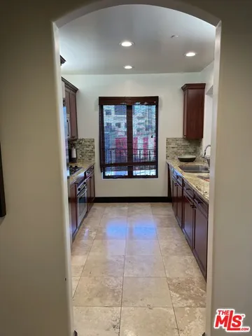 a view of a hallway with a kitchen