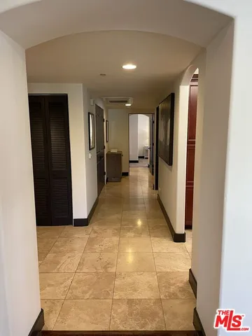 a view of a hallway with furniture and front door