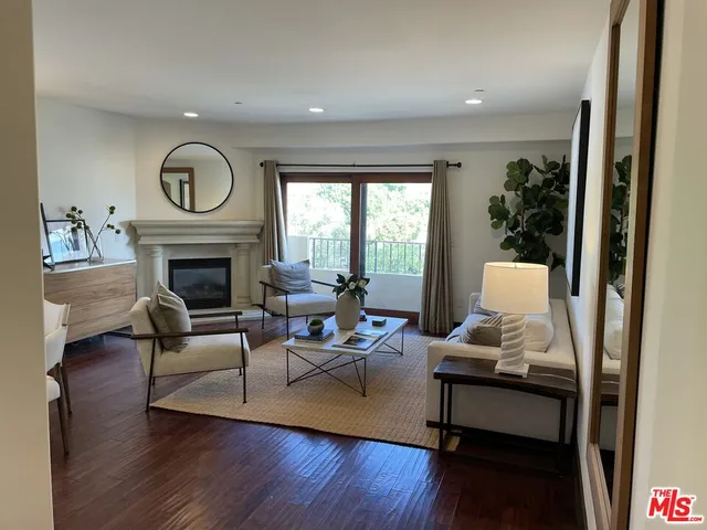 a living room with furniture fireplace and window
