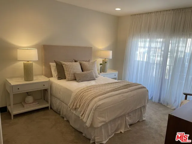 a bedroom with a bed and a lamp