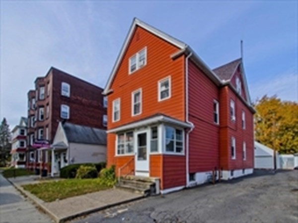 front view of brick house with a yard