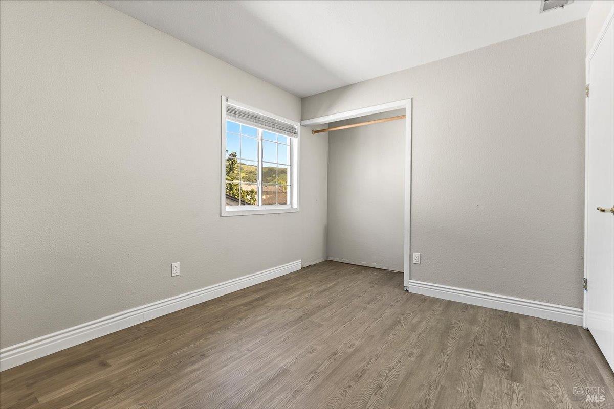 4457 Graywhaler Lane Rohnert Park, CA 94928 - Photo 29 of 51 an empty room with wooden floor and windows