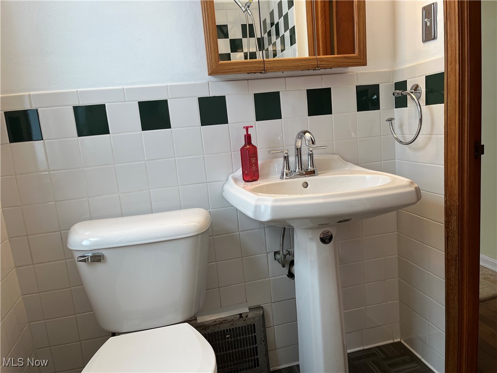 15405 Corkhill Road Maple Heights, OH 44137 - Photo 20 of 50 Bathroom featuring tile walls, toilet and pedestal sink.