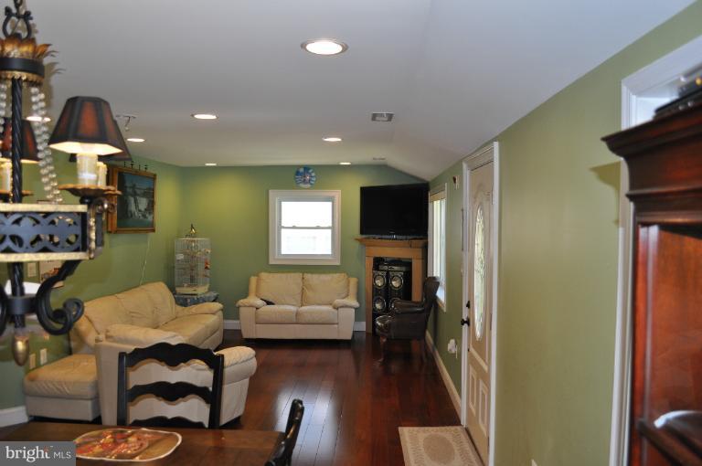 2916 Weisman Road Silver Spring, MD 20902 - Photo 11 of 19 a living room with furniture and a fireplace