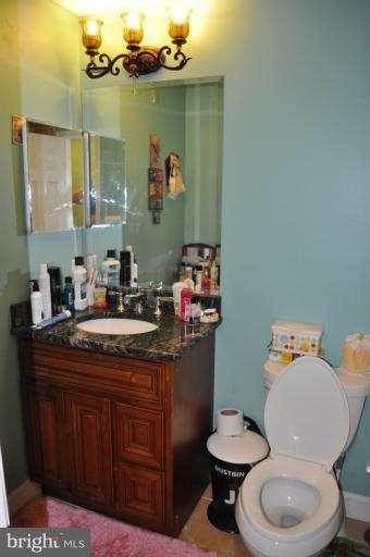 2916 Weisman Road Silver Spring, MD 20902 - Photo 17 of 19 a bathroom with a sink toilet and mirror