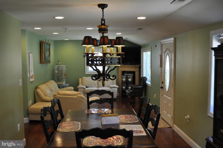 2916 Weisman Road Silver Spring, MD 20902 - Photo 4 of 19 a view of a dining room with furniture a chandelier and wooden floor
