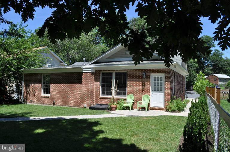 2916 Weisman Road Silver Spring, MD 20902 - Photo 7 of 19 a front view of a house with a garden and yard