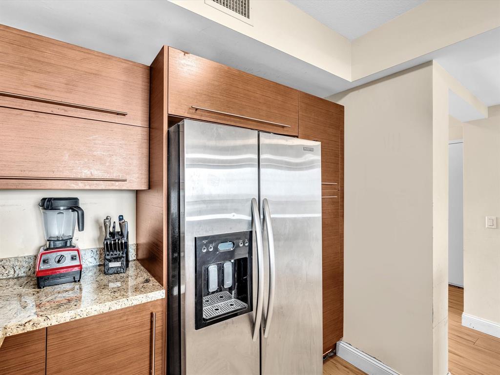 2681 North Flamingo Road, Unit 2104S Fort Lauderdale, FL 33323 - Photo 12 of 99 a kitchen with stainless steel appliances granite countertop a refrigerator and a sink