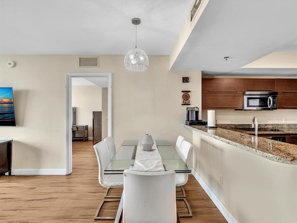 2681 North Flamingo Road, Unit 2104S Fort Lauderdale, FL 33323 - Photo 18 of 99 a kitchen with stainless steel appliances granite countertop a stove refrigerator and cabinets
