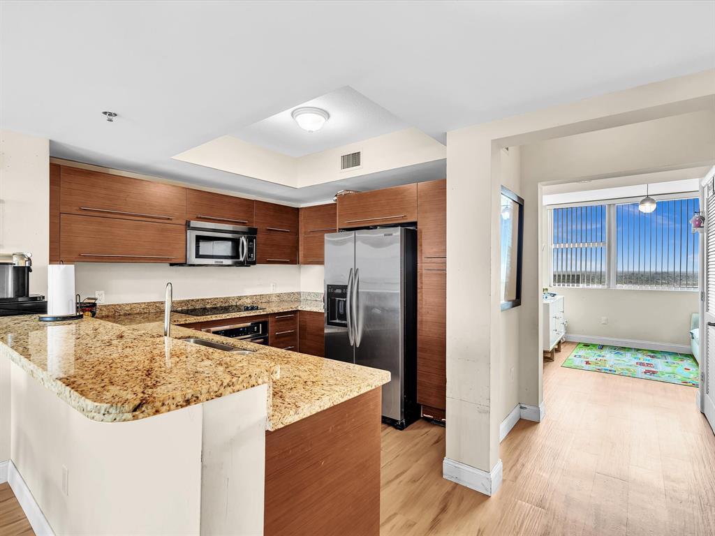 2681 North Flamingo Road, Unit 2104S Fort Lauderdale, FL 33323 - Photo 22 of 99 a kitchen with stainless steel appliances granite countertop a refrigerator and a sink