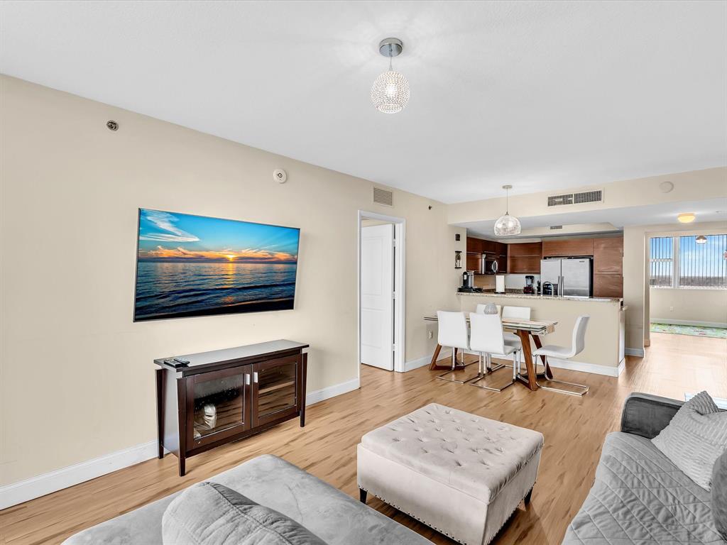 2681 North Flamingo Road, Unit 2104S Fort Lauderdale, FL 33323 - Photo 23 of 99 a living room with furniture and a flat screen tv