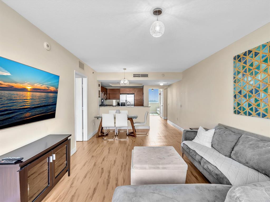 2681 North Flamingo Road, Unit 2104S Fort Lauderdale, FL 33323 - Photo 35 of 99 a living room with furniture and a flat screen tv